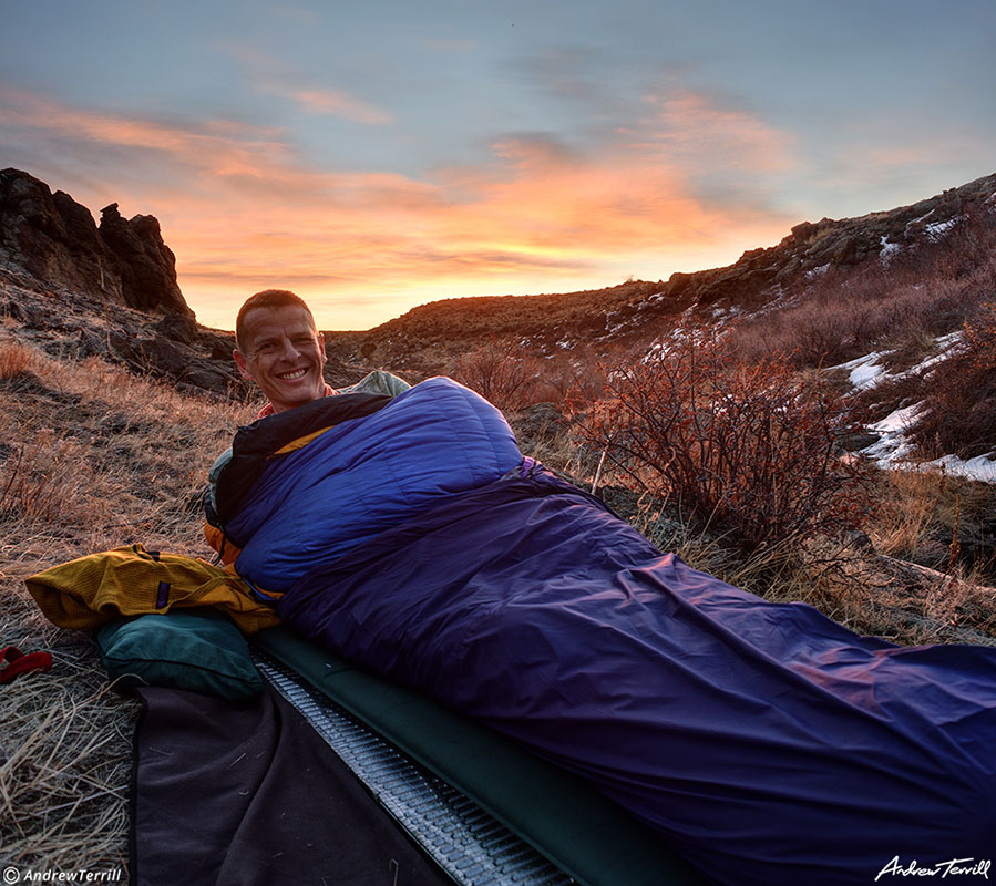 andrew terrill hiker in sleeping bag and bivvy bag at sunrise cowboy camping