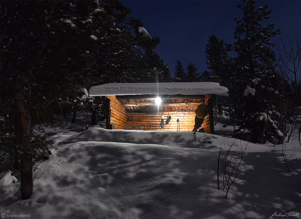 appalachian lean to cabin shelter in moonlit winter forest in snow in golden gate canyon state park colorado