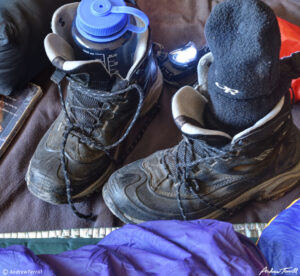 hiking boots and water bottle winter camping skills and tricks 12-13-22