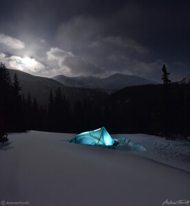 tent glowing at night during winter camp in snow in colorado near mount evans wilderness