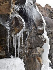 thawing waterfall with icicles on north table mountain golden colorado