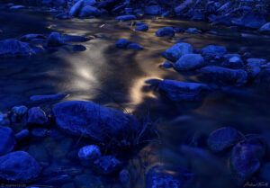 light reflection on mountain stream by night