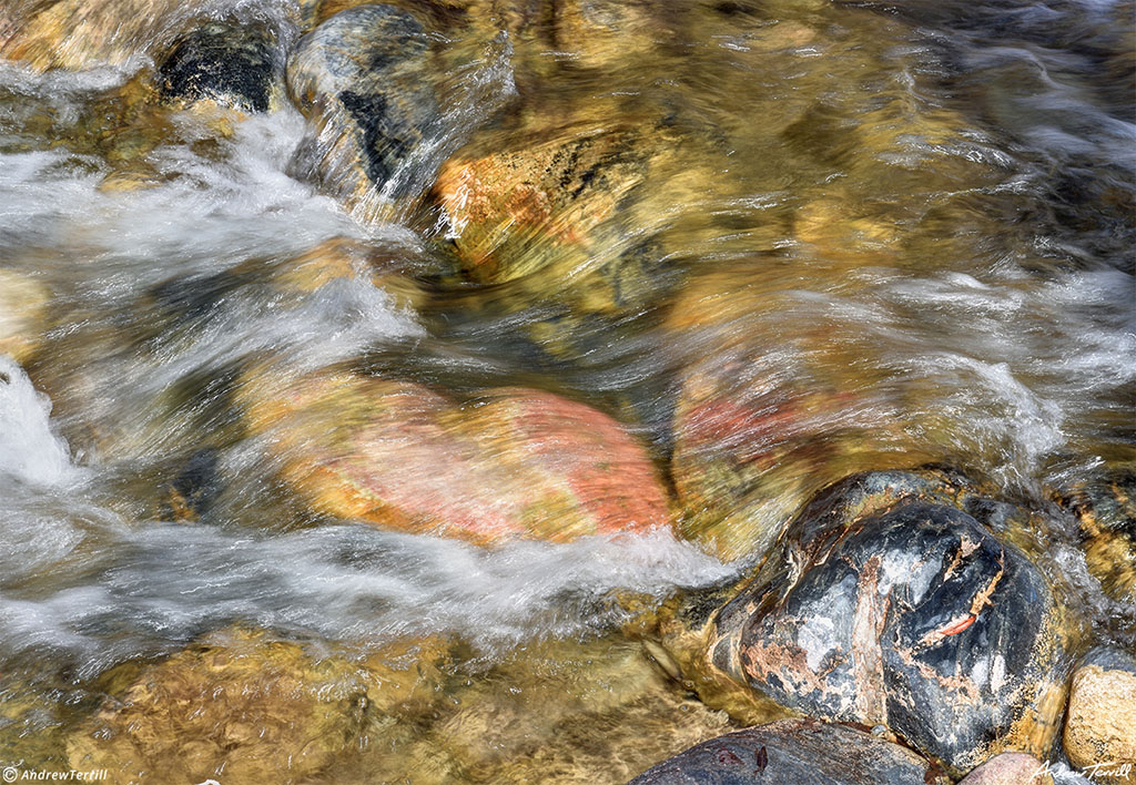 mountain creek gushing downhill blurred water