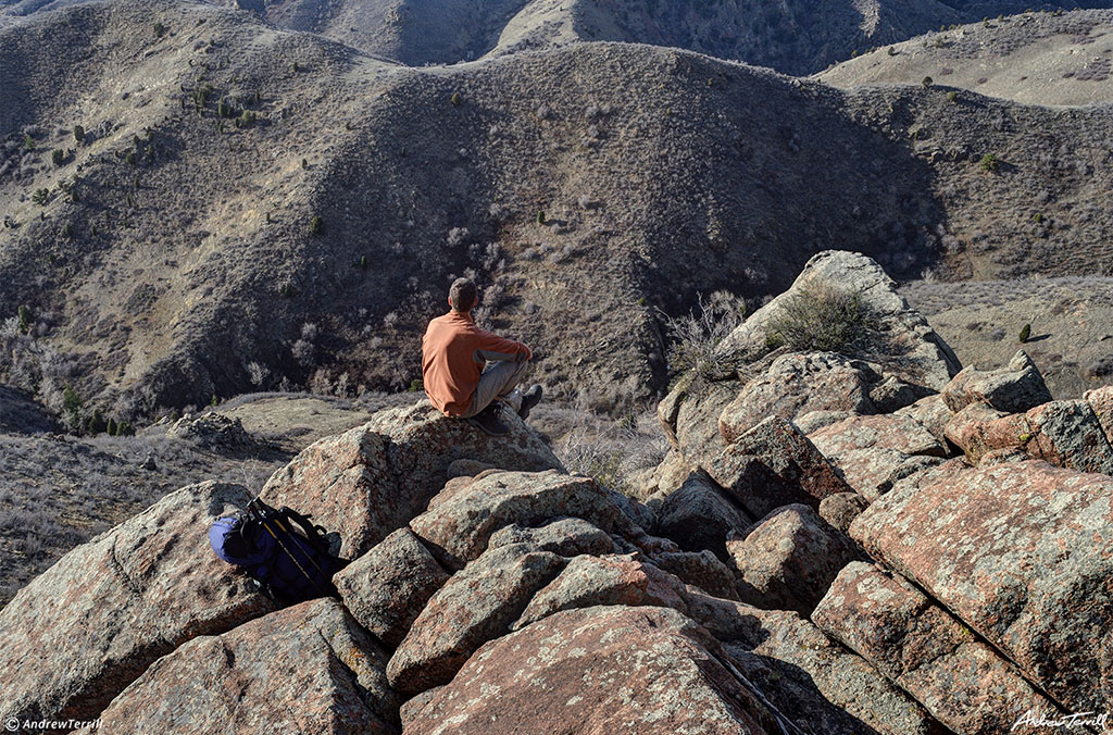 sitting on mountain with view across valley