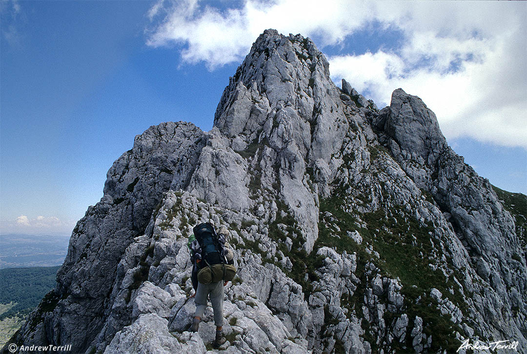 andrew terrill hiker backpacker on narrow knife edge ridge in abruzzo apennines italy