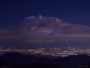 nighttime thundercloud above sea of lights may 2021 colorado