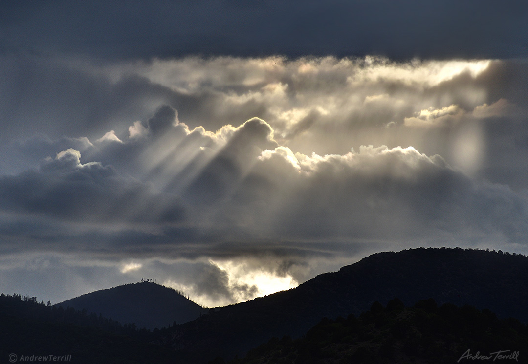 sunbeams over forested mountains Colorado