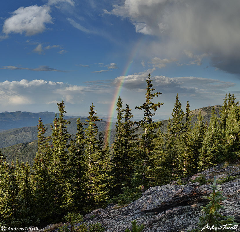 rainbow over colorado foothills and forests august