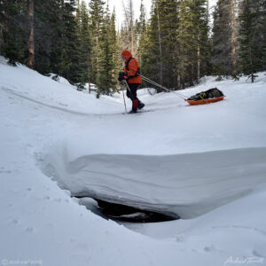 igloo ed hiking across snow bridge