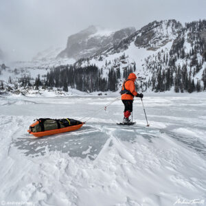 igloo ed pulling pulk across lake haiyaha colorado