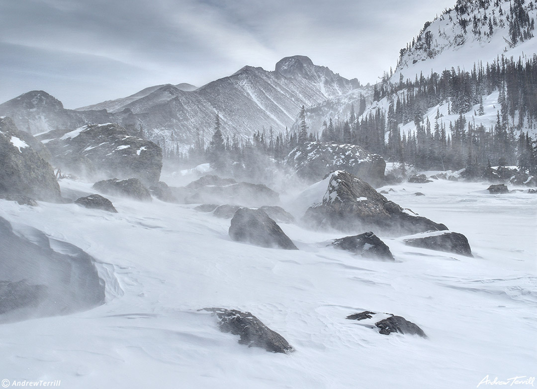 lake haiyaha and longs peak in winter with strong winds and spindrift