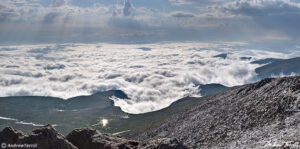 cloud sea beneath mount evans