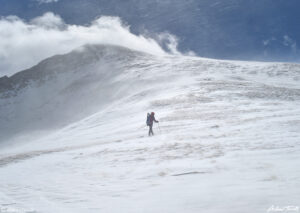 006 small figure heading up mount bierstadt on a windy day with spindrift colorado