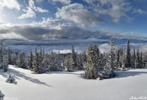 snowy winter mountain in colorado above the clouds