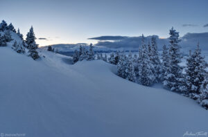 deep snow on mountain after sunset in cold frozen light