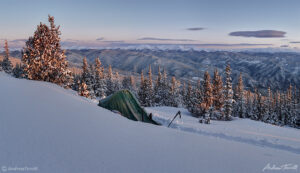 winter sunrise with alpenglow on frosted tent wild camping in colorado