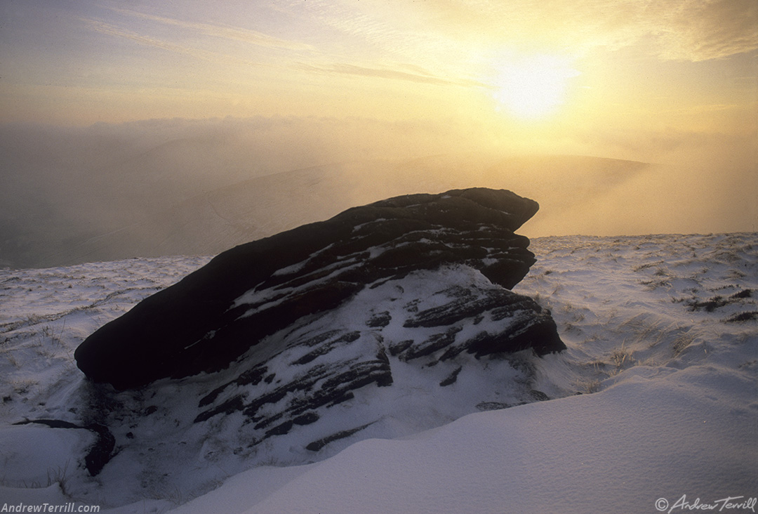 kinder scout winter sunset and fog rock