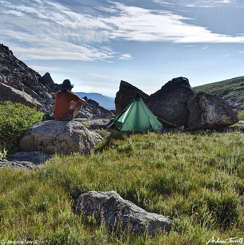 hiker on rock in camp morning tumbling creek - colorado - 5 aug 2023